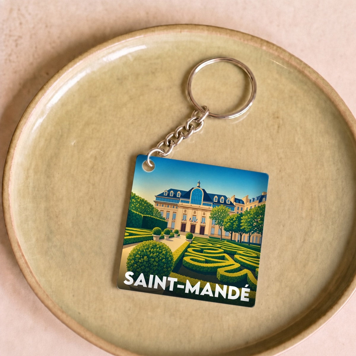 Porte-clés souvenir de la ville de Saint-Mandé avec une illustration stylisée.