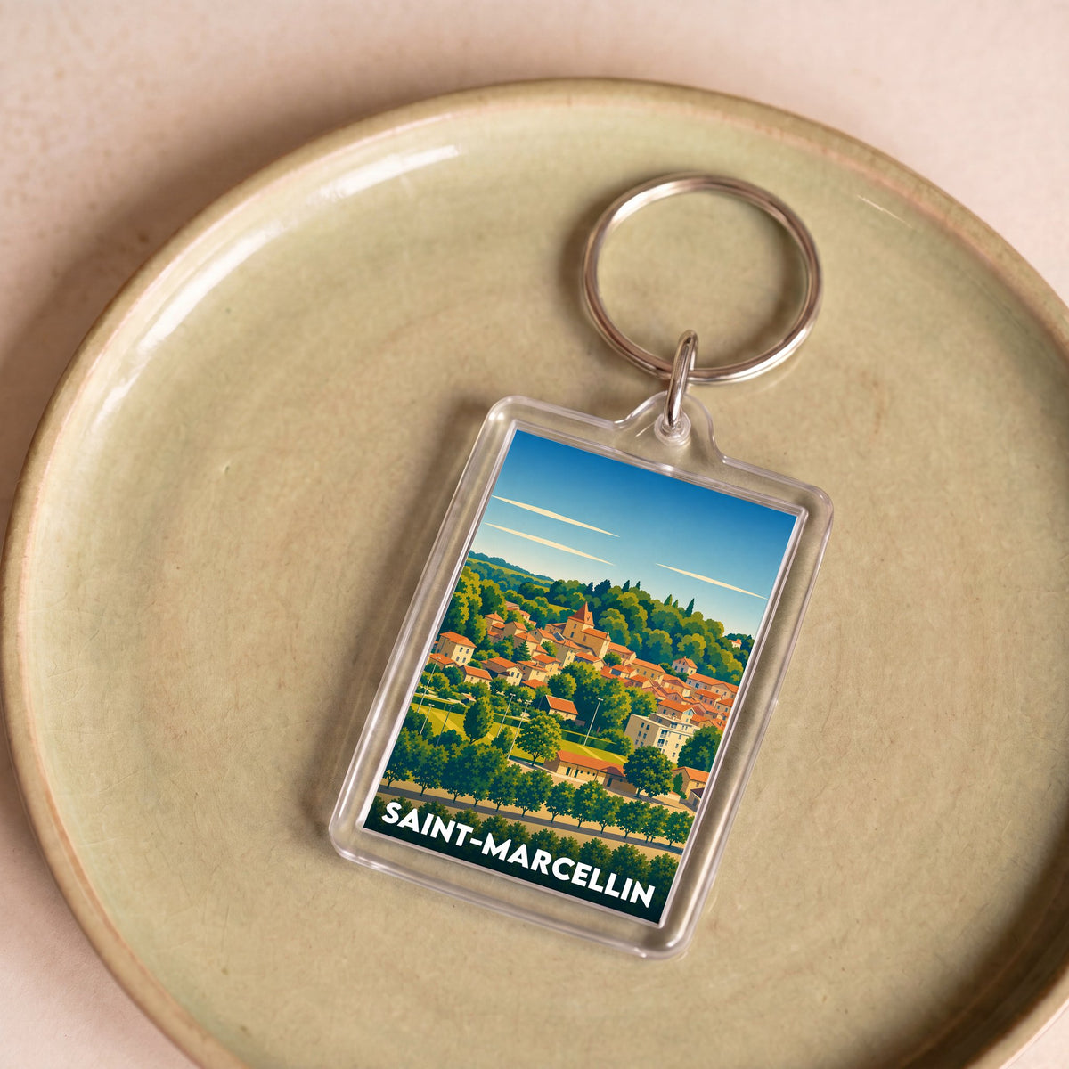 Porte-clés souvenir de la ville de Saint-Marcellin avec une illustration stylisée.