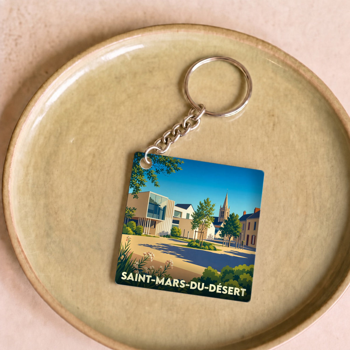 Porte-clés souvenir de la ville de Saint-Mars-du-Désert avec une illustration stylisée.