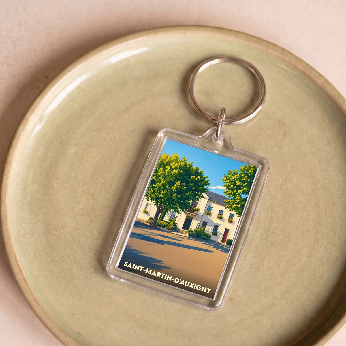 Porte-clés souvenir de la ville de Saint-Martin-d'Auxigny avec une illustration stylisée.
