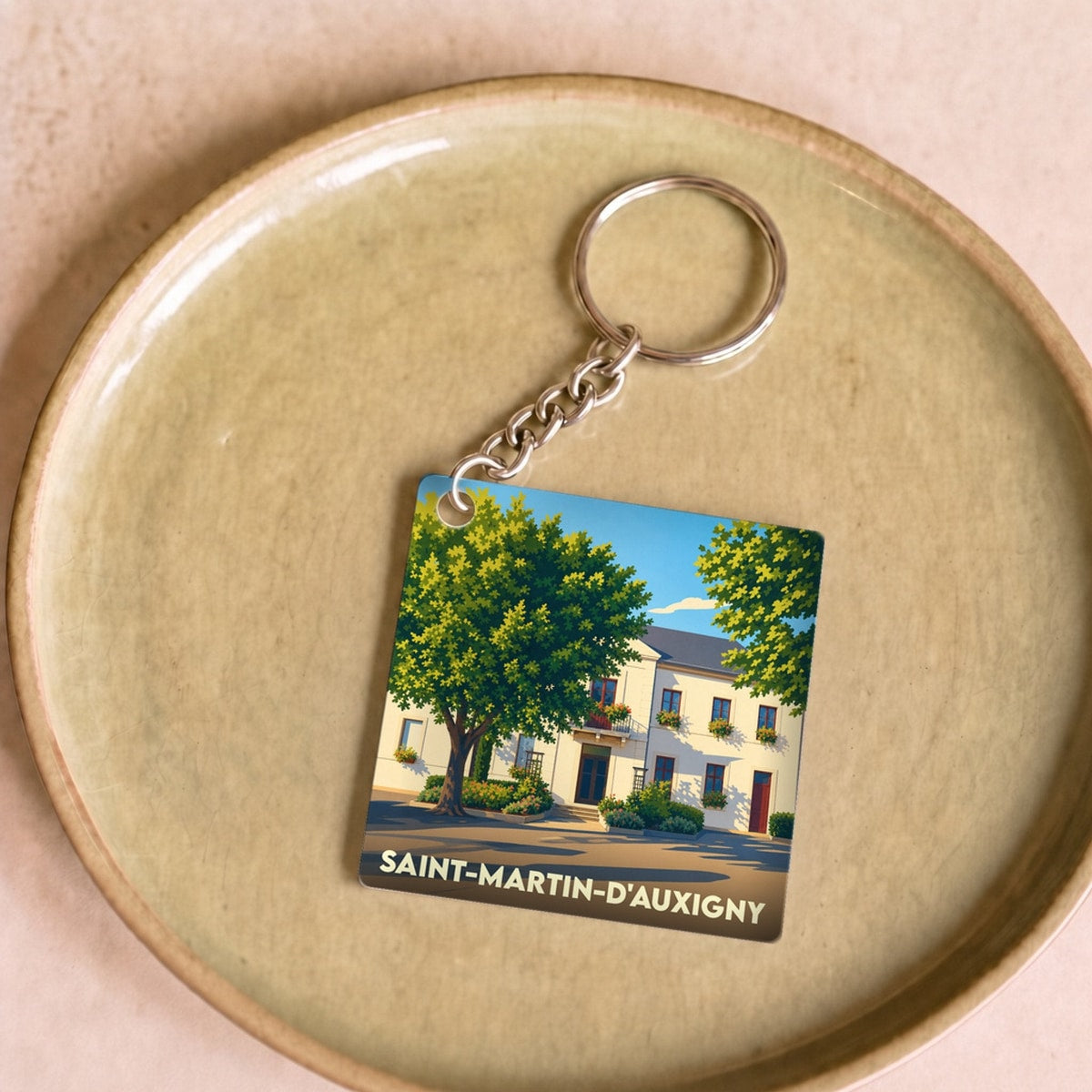 Porte-clés souvenir de la ville de Saint-Martin-d'Auxigny avec une illustration stylisée.