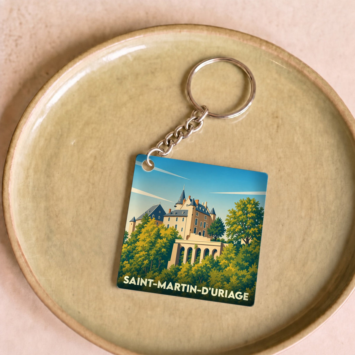 Porte-clés souvenir de la ville de Saint-Martin-d'Uriage avec une illustration stylisée de son château.