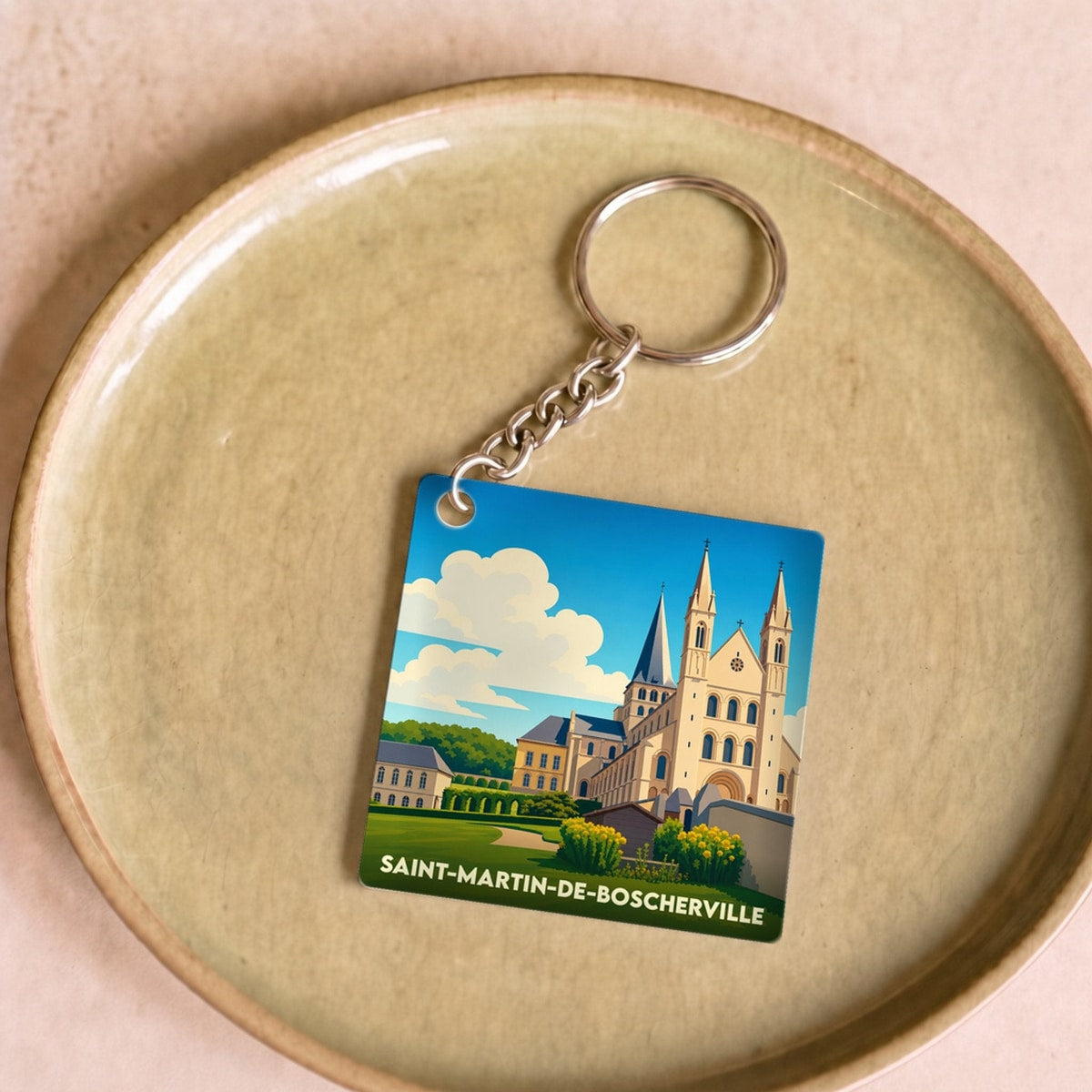 Porte-clés souvenir de la ville de Saint-Martin-de-Boscherville avec une illustration stylisée de son abbaye.