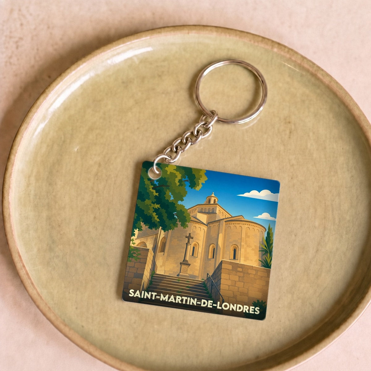 Porte-clés souvenir de Saint-Martin-de-Londres avec une illustration stylisée de son église romane.