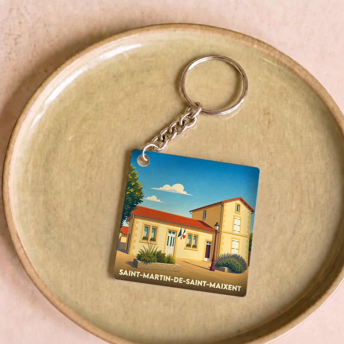 Porte-clés souvenir de la ville de Saint-Martin-de-Saint-Maixent avec une illustration stylisée de sa mairie.