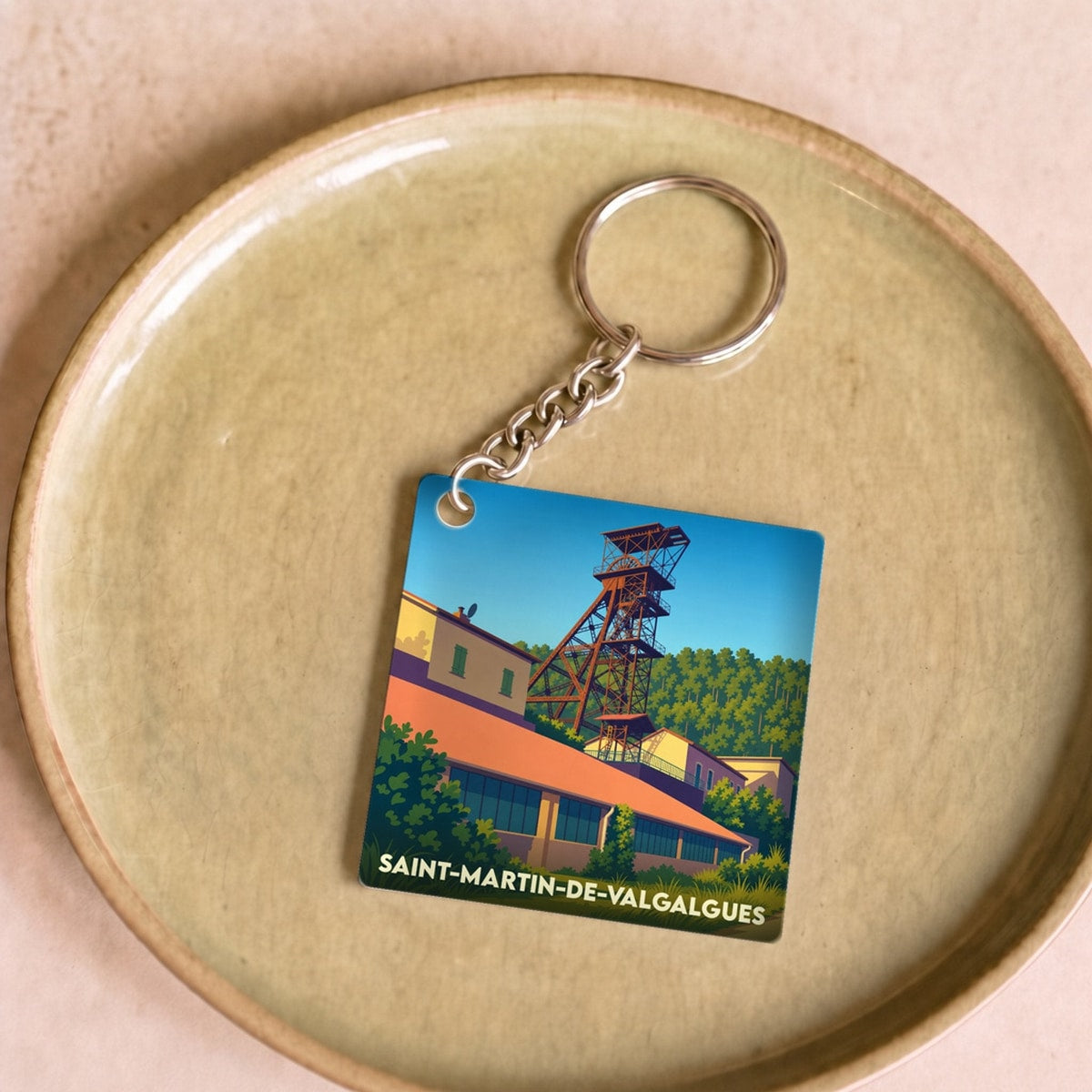Porte-clés souvenir de la ville de Saint-Martin-de-Valgalgues avec une illustration stylisée d'un ancien puits de mine.