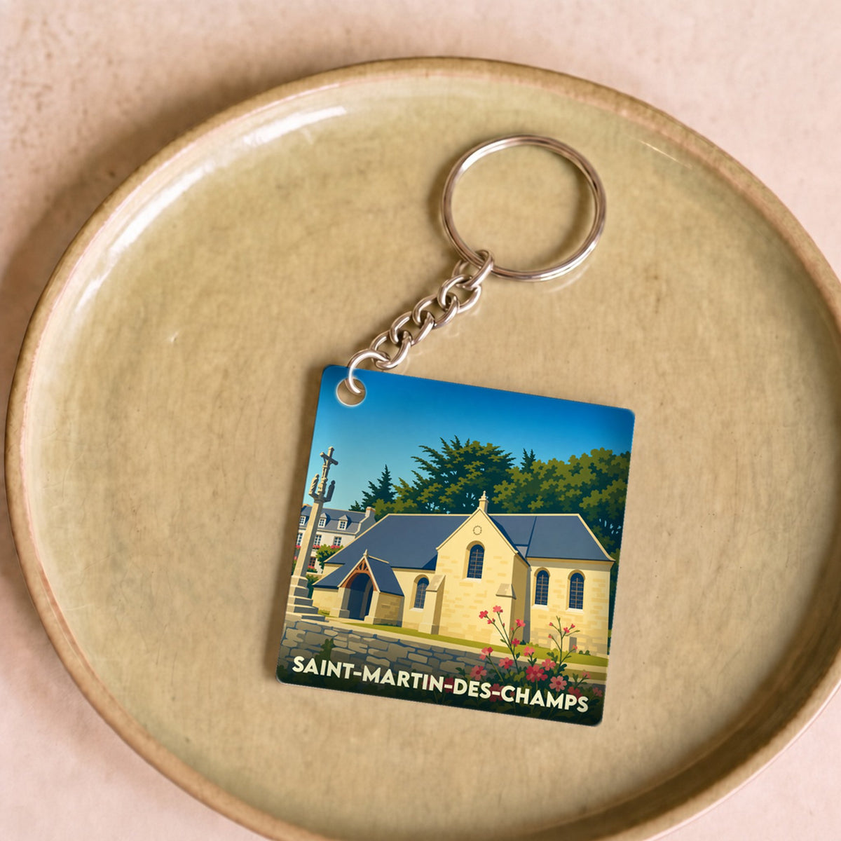 Porte-clés souvenir de la ville de Saint-Martin-des-Champs avec une illustration stylisée.