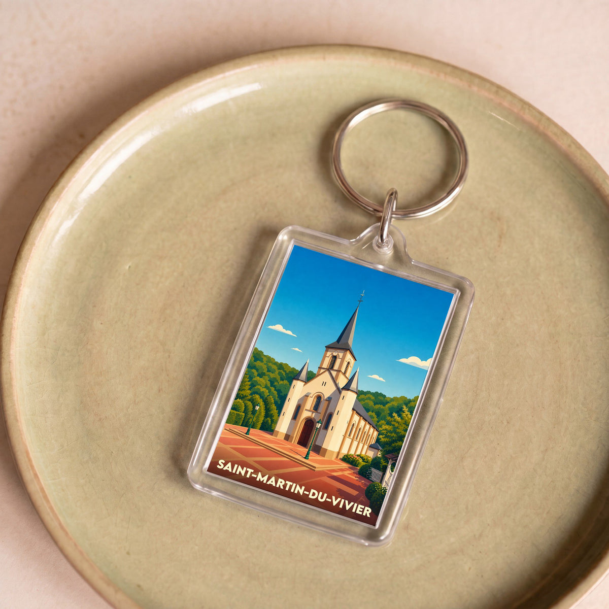 Porte-clés souvenir de la ville de Saint-Martin-du-Vivier avec une illustration stylisée de son église.