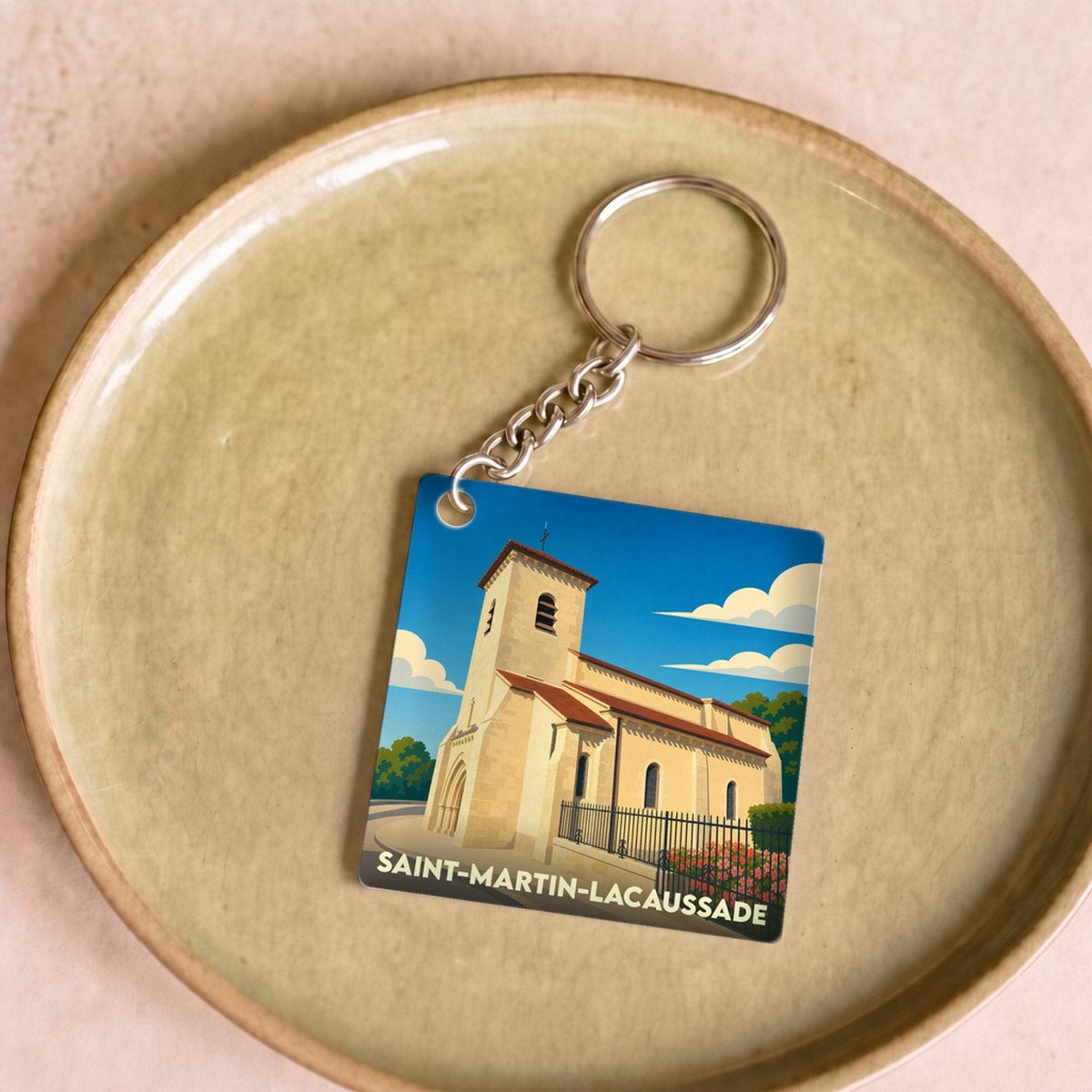 Porte-clés souvenir de la ville de Saint-Martin-Lacaussade avec une illustration stylisée de son église.