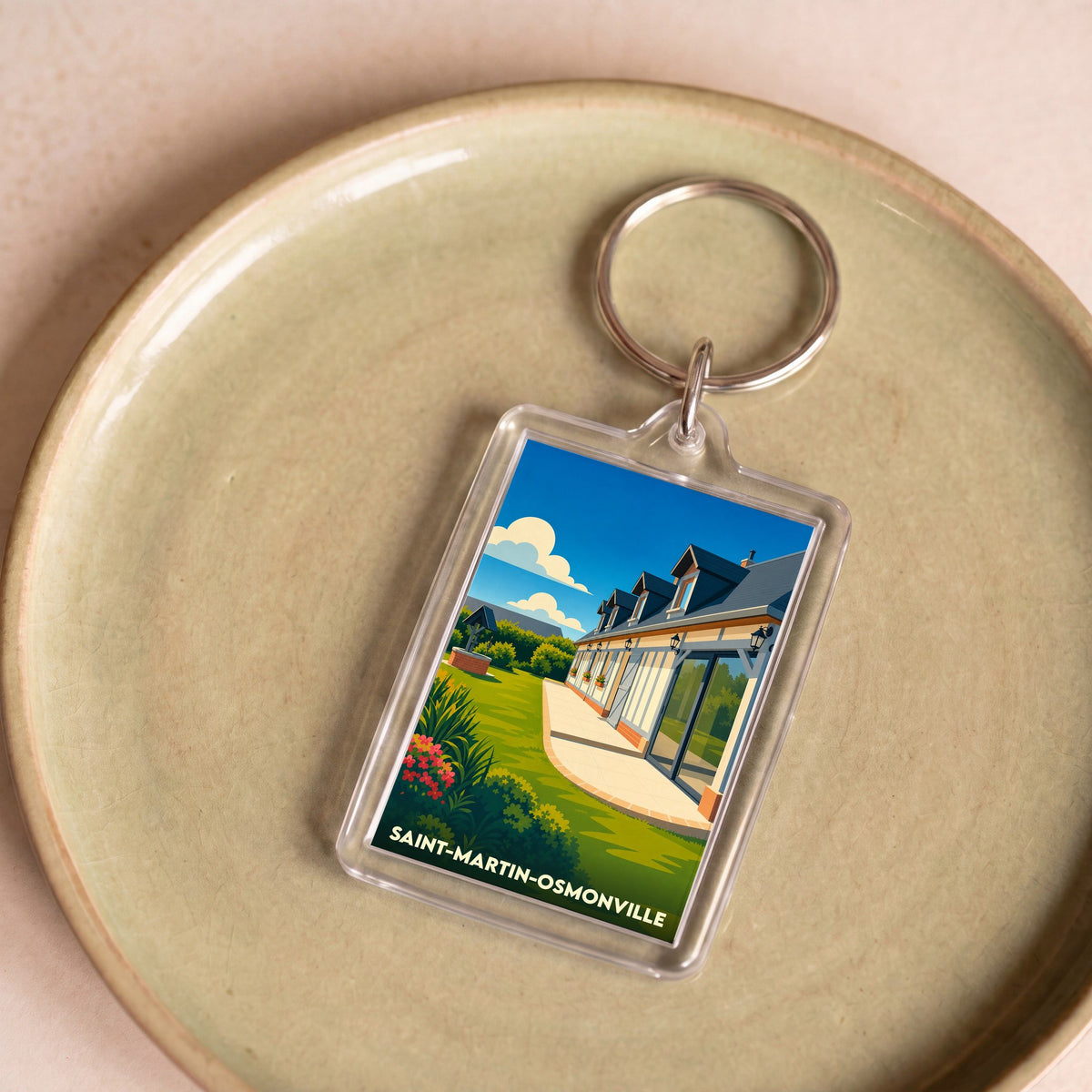 Porte-clés souvenir de la ville de Saint-Martin-Osmonville avec une illustration stylisée d'une maison normande.