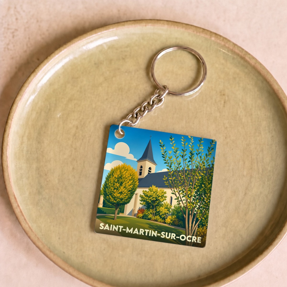 Porte-clés souvenir de la ville de Saint-Martin-sur-Ocre avec une illustration stylisée de son église.