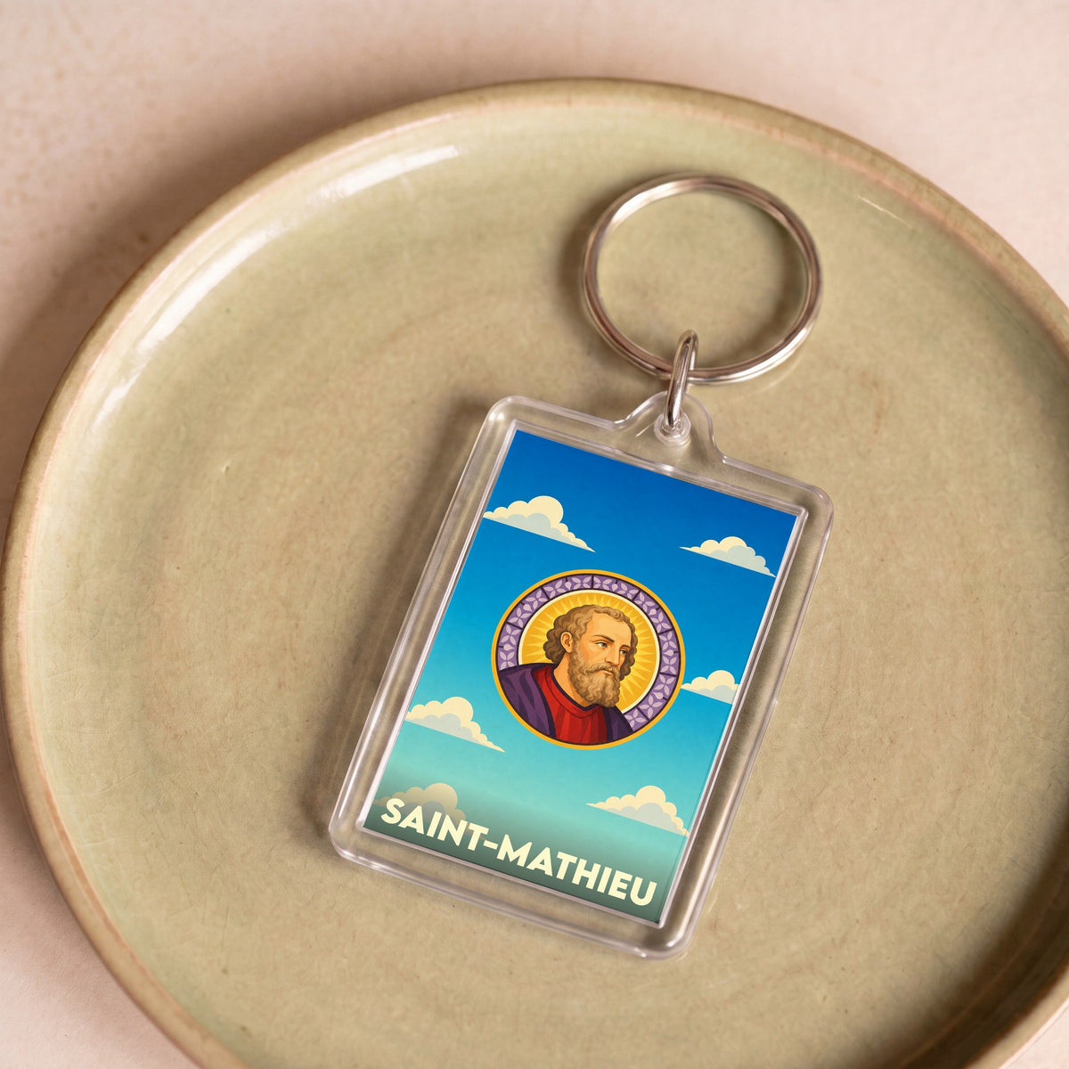 Porte-clés souvenir de la ville de Saint-Mathieu avec une illustration stylisée.