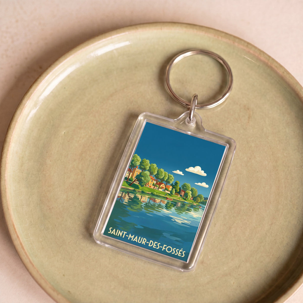 Porte-clés souvenir de la ville de Saint-Maur-des-Fossés avec une illustration stylisée.