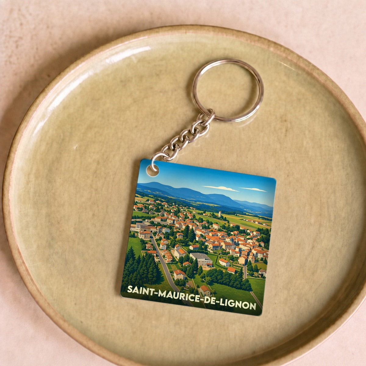 Porte-clés souvenir de la ville de Saint-Maurice-de-Lignon avec une illustration stylisée.
