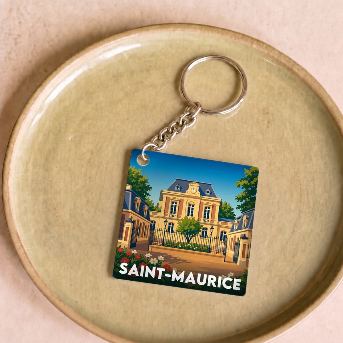 Porte-clés souvenir de la ville de Saint-Maurice avec une illustration stylisée.