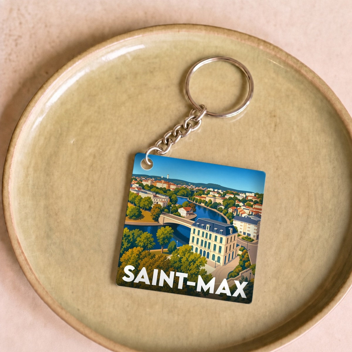 Porte-clés souvenir de la ville de Saint-Max avec une illustration stylisée.