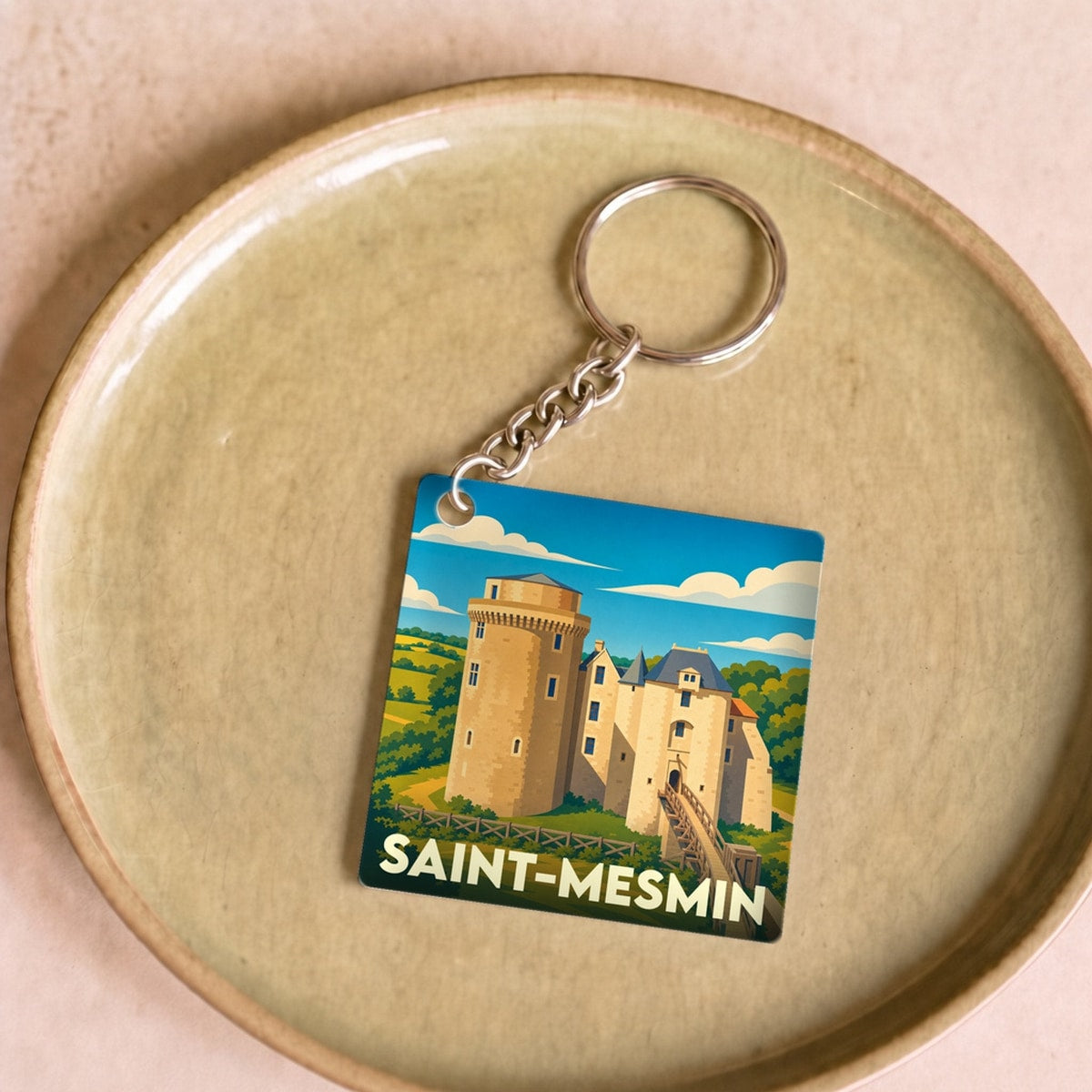 Porte-clés souvenir de la ville de Saint-Mesmin avec une illustration stylisée de son château.