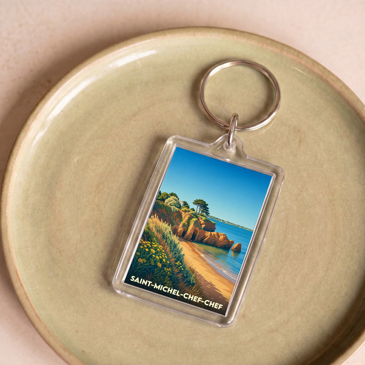 Porte-clés souvenir de la ville de Saint-Michel-Chef-Chef avec une illustration stylisée de son littoral.