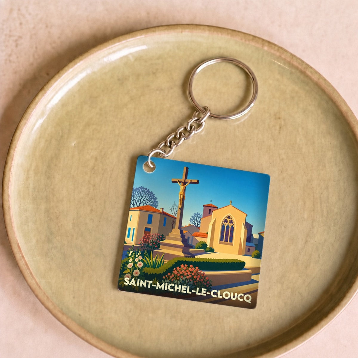 Porte-clés souvenir de la ville de Saint-Michel-le-Cloucq avec une illustration stylisée.