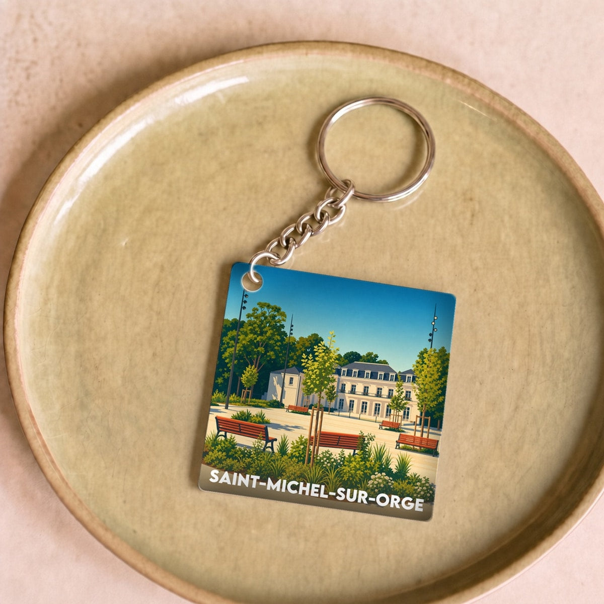 Porte-clés souvenir de la ville de Saint-Michel-sur-Orge avec une illustration stylisée d'un parc.