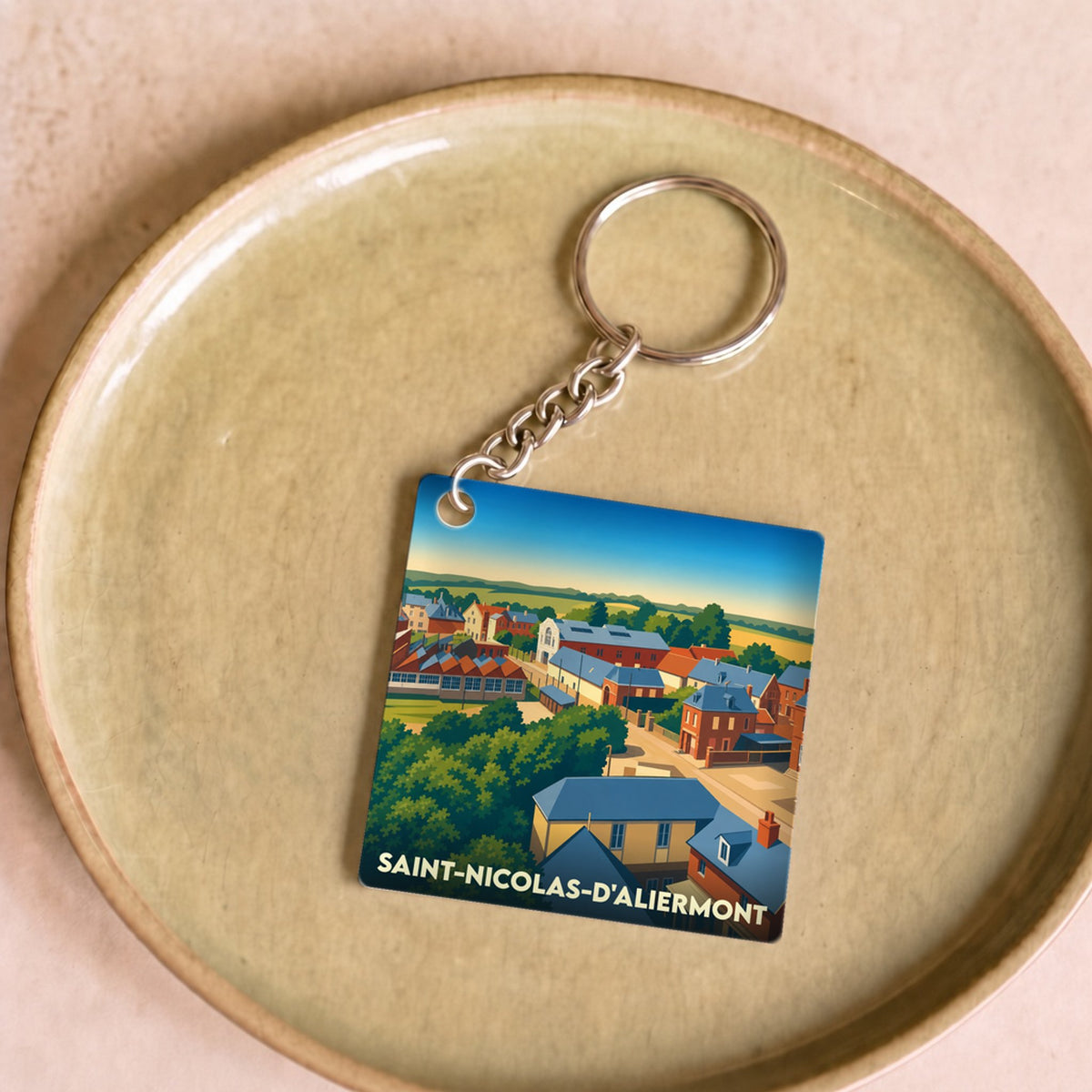 Porte-clés souvenir de la ville de Saint-Nicolas-d'Aliermont avec une illustration stylisée.