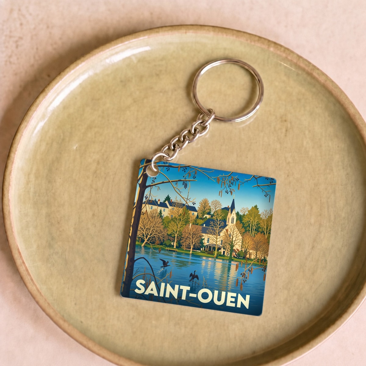 Porte-clés souvenir de la ville de Saint-Ouen avec une illustration stylisée.