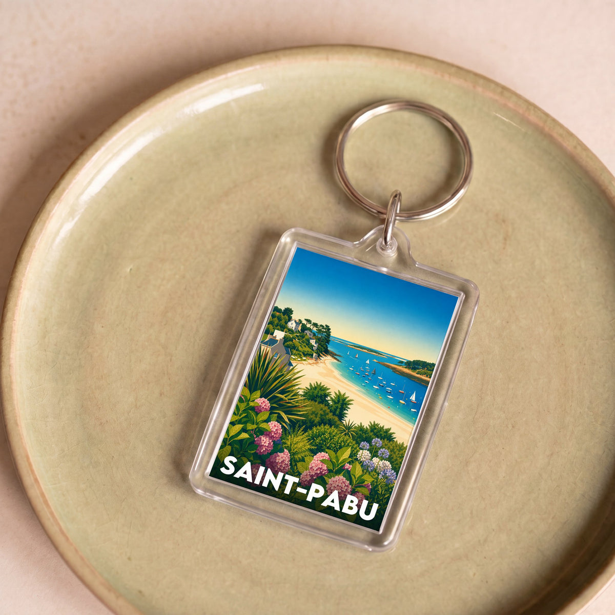 Porte-clés souvenir de la ville de Saint-Pabu avec une illustration stylisée.