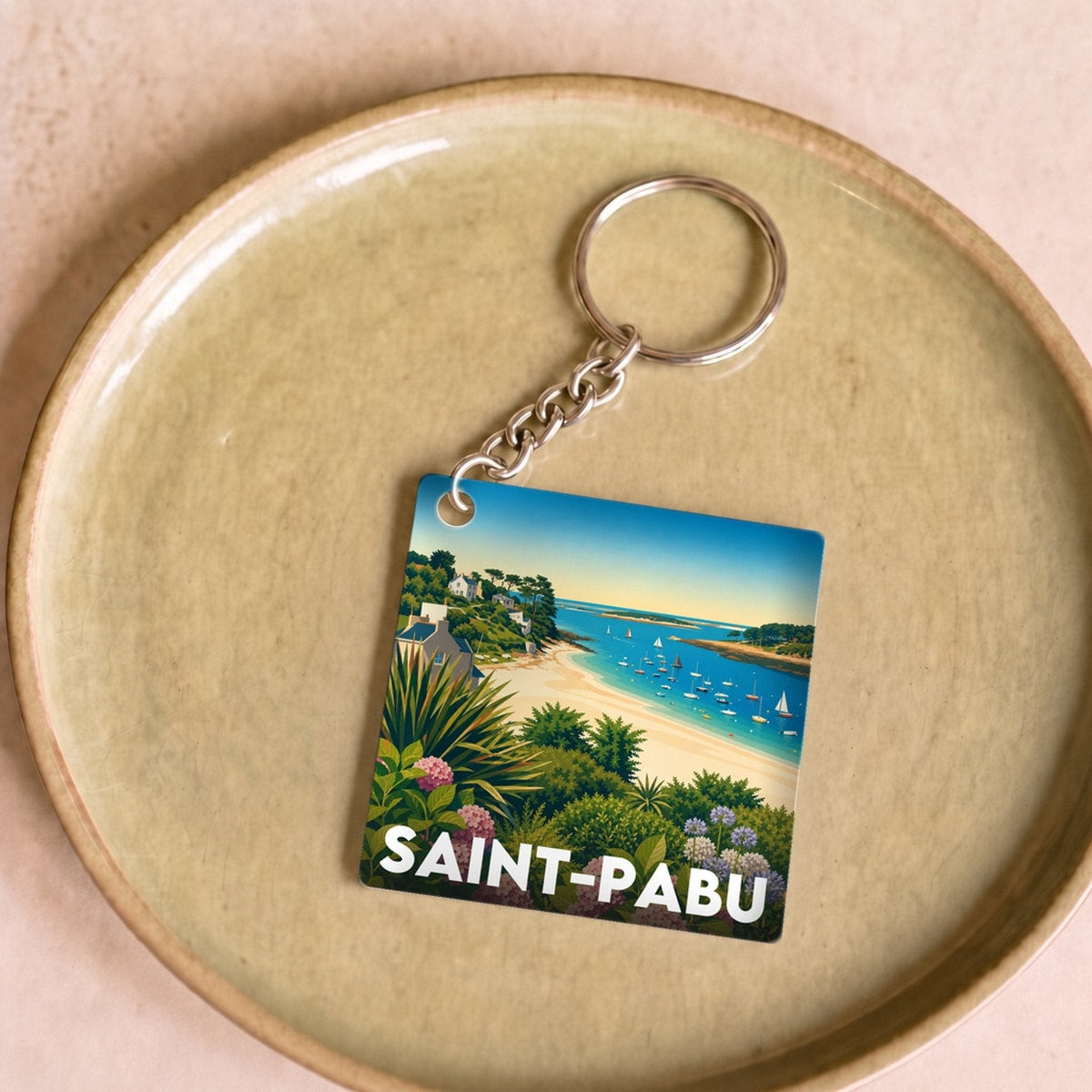 Porte-clés souvenir de la ville de Saint-Pabu avec une illustration stylisée.