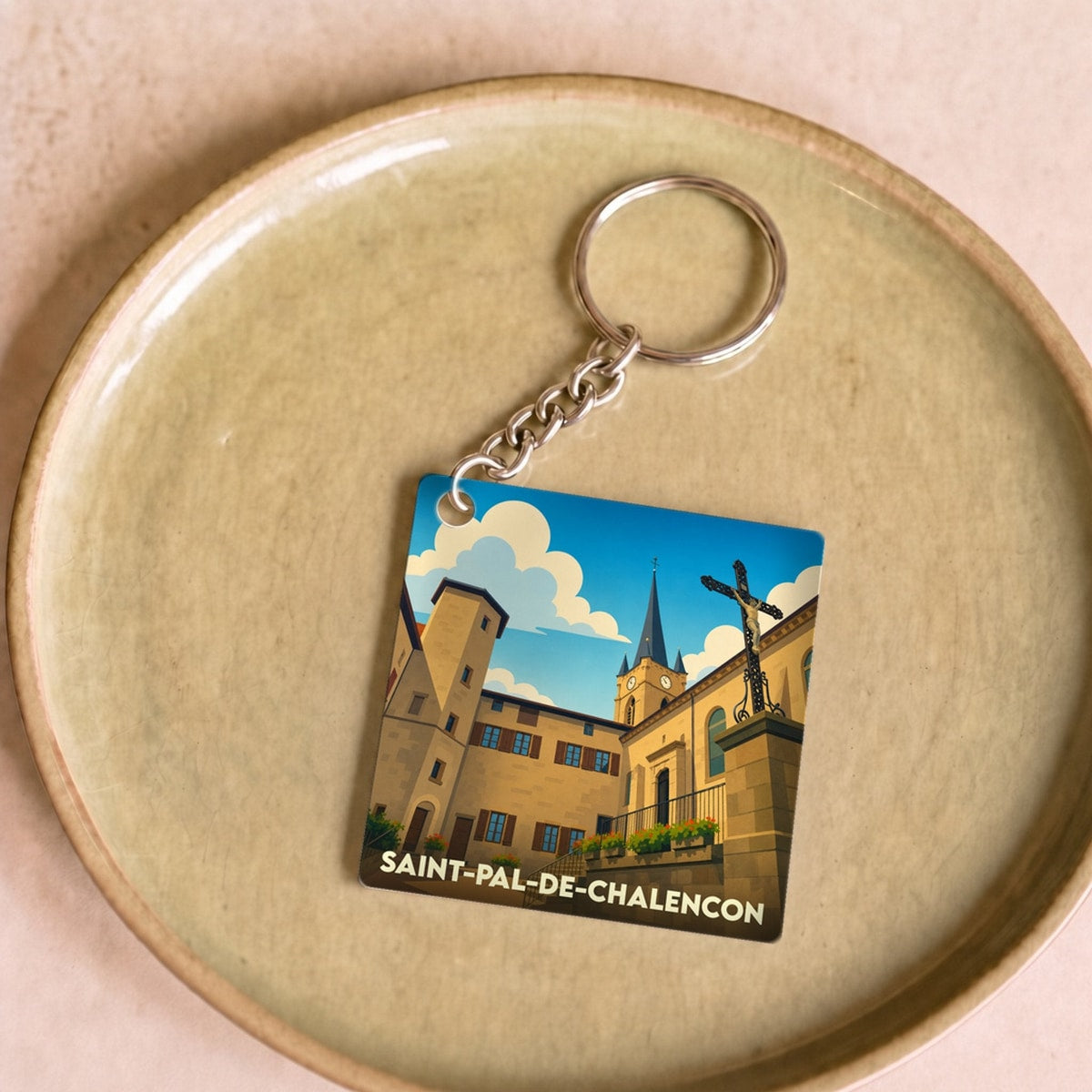 Porte-clés souvenir de la ville de Saint-Pal-de-Chalencon avec une illustration stylisée.
