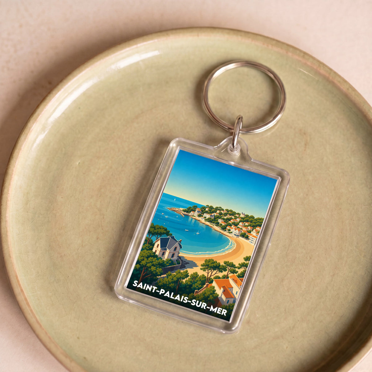 Porte-clés souvenir de la ville de Saint-Palais-sur-Mer avec une illustration stylisée de son littoral.