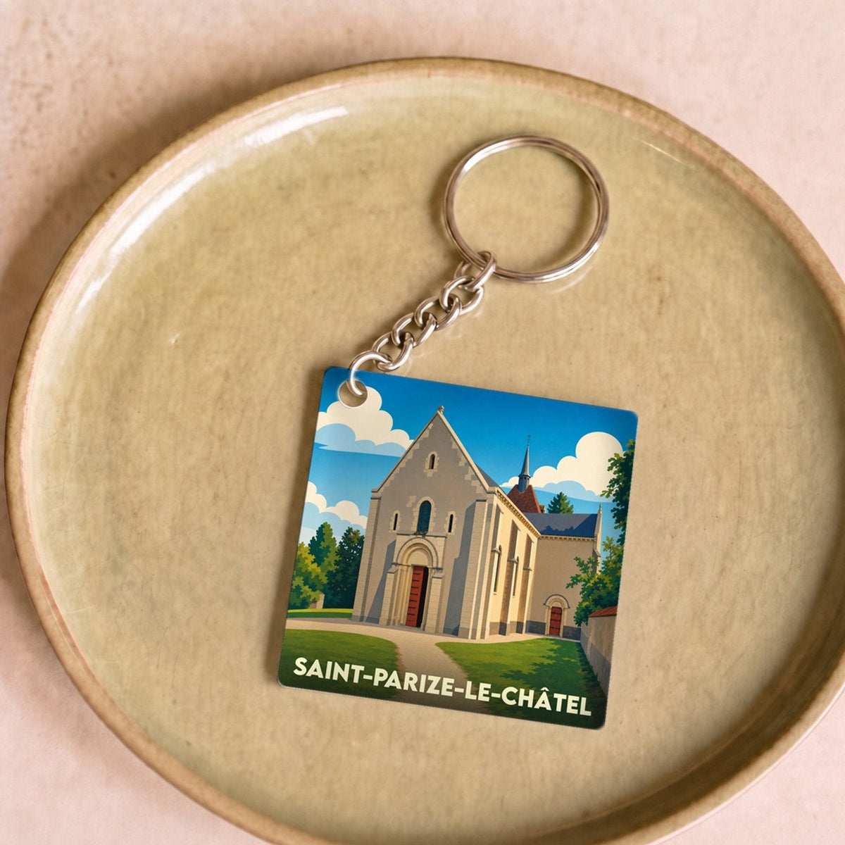 Porte-clés souvenir de Saint-Parize-le-Châtel avec une illustration stylisée de son église romane.