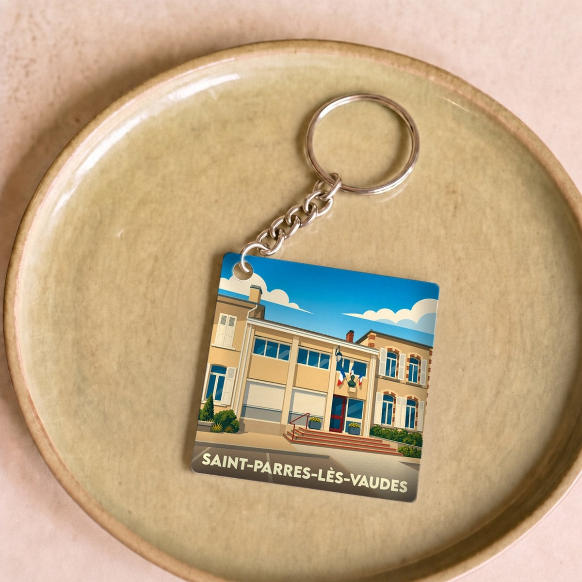 Porte-clés souvenir de la ville de Saint-Parres-lès-Vaudes avec une illustration stylisée.