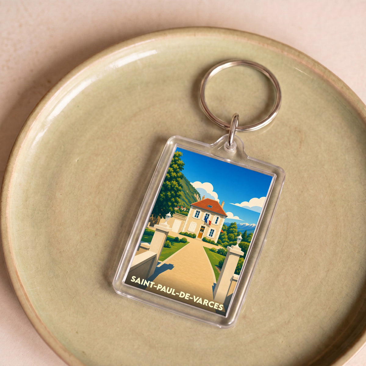 Porte-clés souvenir de la ville de Saint-Paul-de-Varces avec une illustration stylisée.