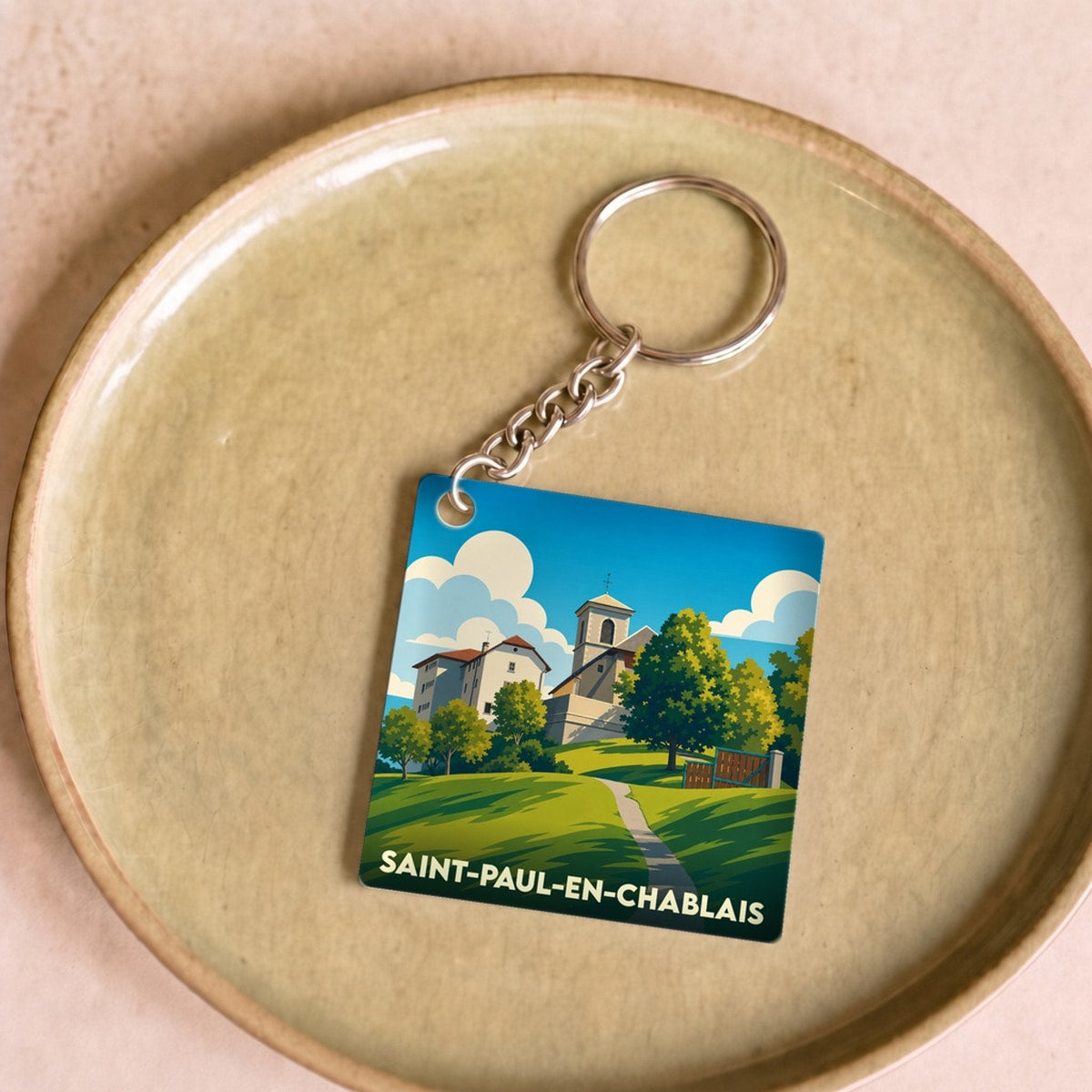 Porte-clés souvenir de la ville de Saint-Paul-en-Chablais avec une illustration stylisée.