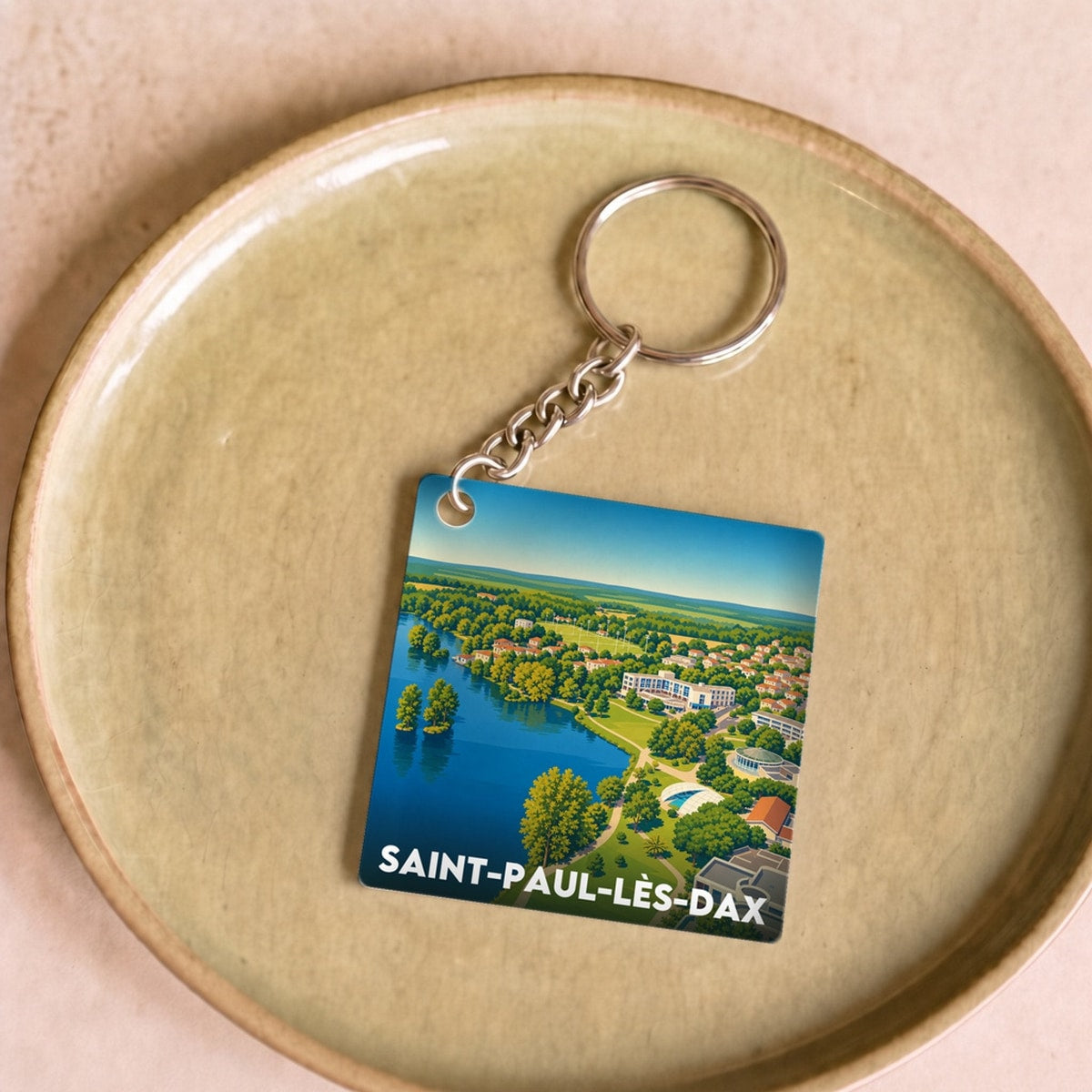 Porte-clés souvenir de la ville de Saint-Paul-lès-Dax avec une illustration stylisée.