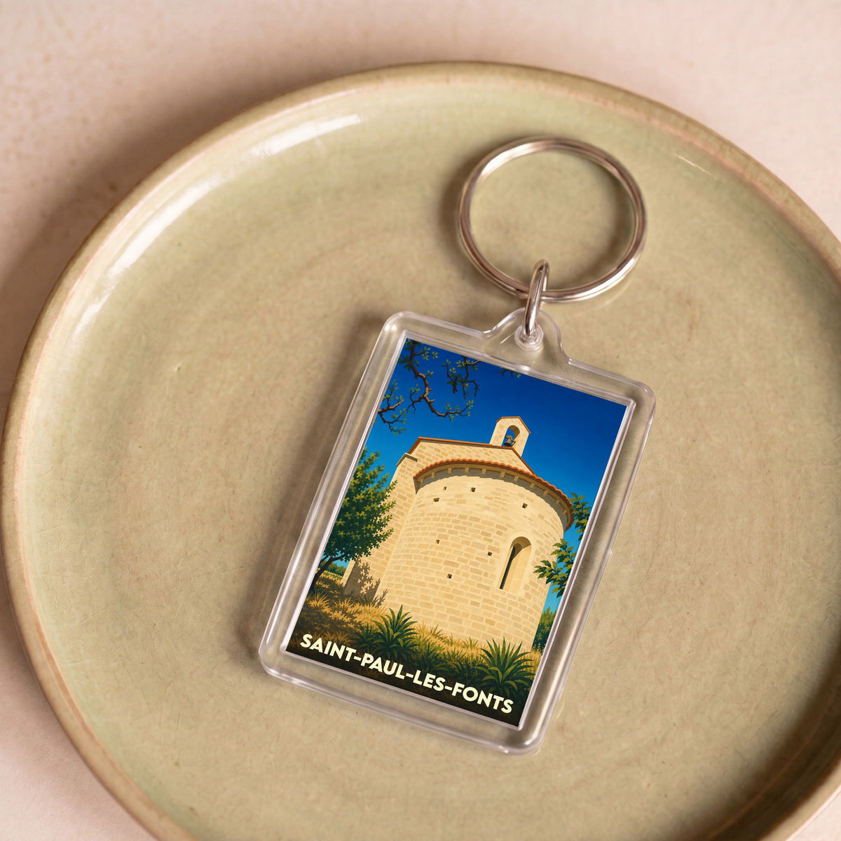Porte-clés souvenir de la ville de Saint-Paul-les-Fonts avec une illustration stylisée.
