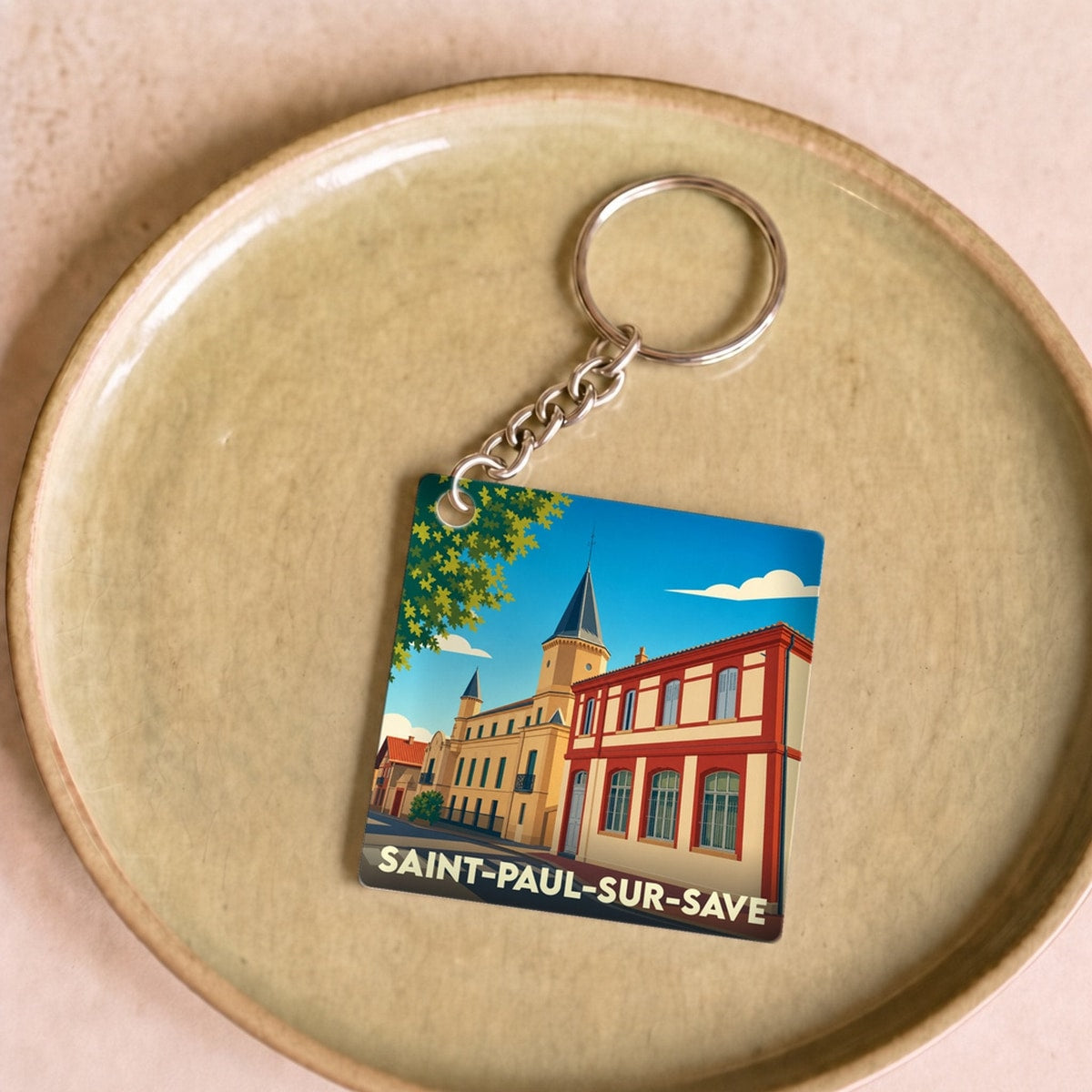 Porte-clés souvenir de la ville de Saint-Paul-sur-Save avec une illustration stylisée.
