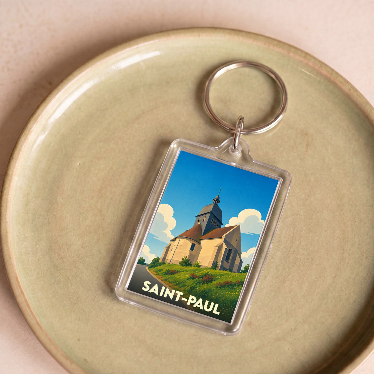 Porte-clés souvenir de la ville de Saint-Paul avec une illustration stylisée de son église.