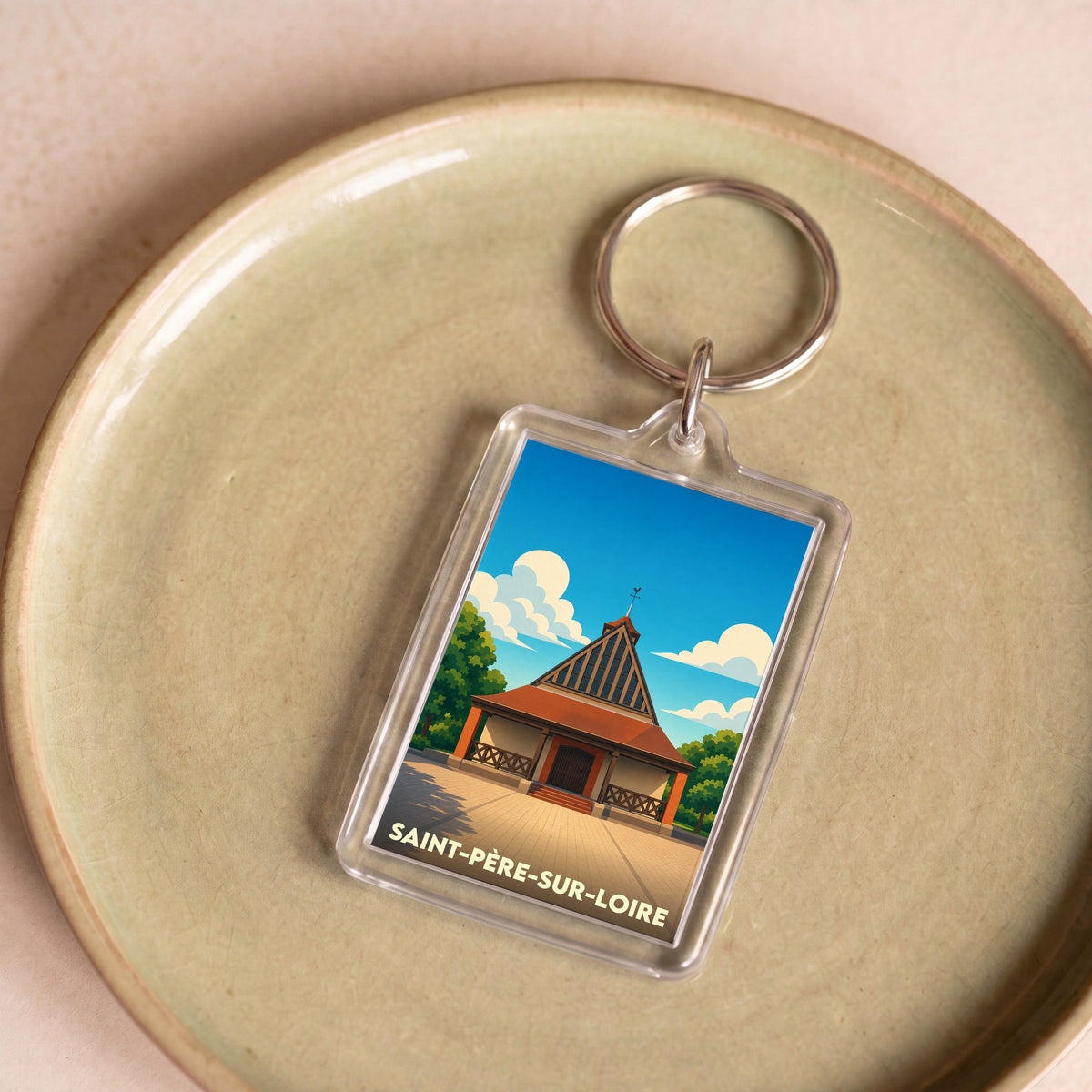 Porte-clés souvenir de la ville de Saint-Père-sur-Loire avec une illustration stylisée de son église.