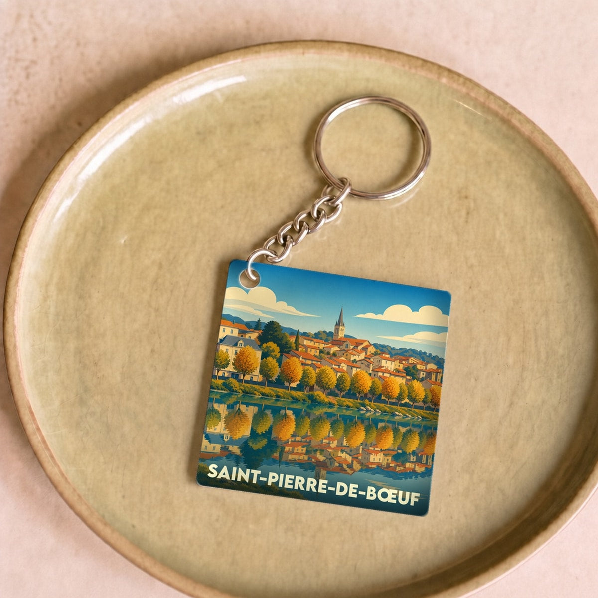 Porte-clés souvenir de la ville de Saint-Pierre-de-Bœuf avec une illustration stylisée.
