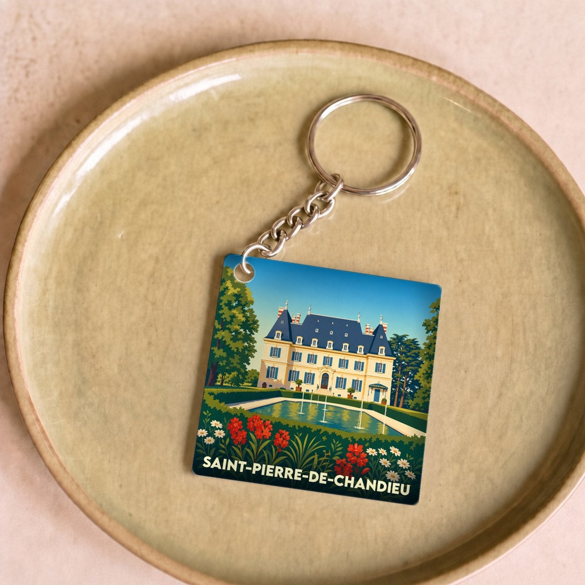 Porte-clés souvenir de la ville de Saint-Pierre-de-Chandieu avec une illustration stylisée de son château.