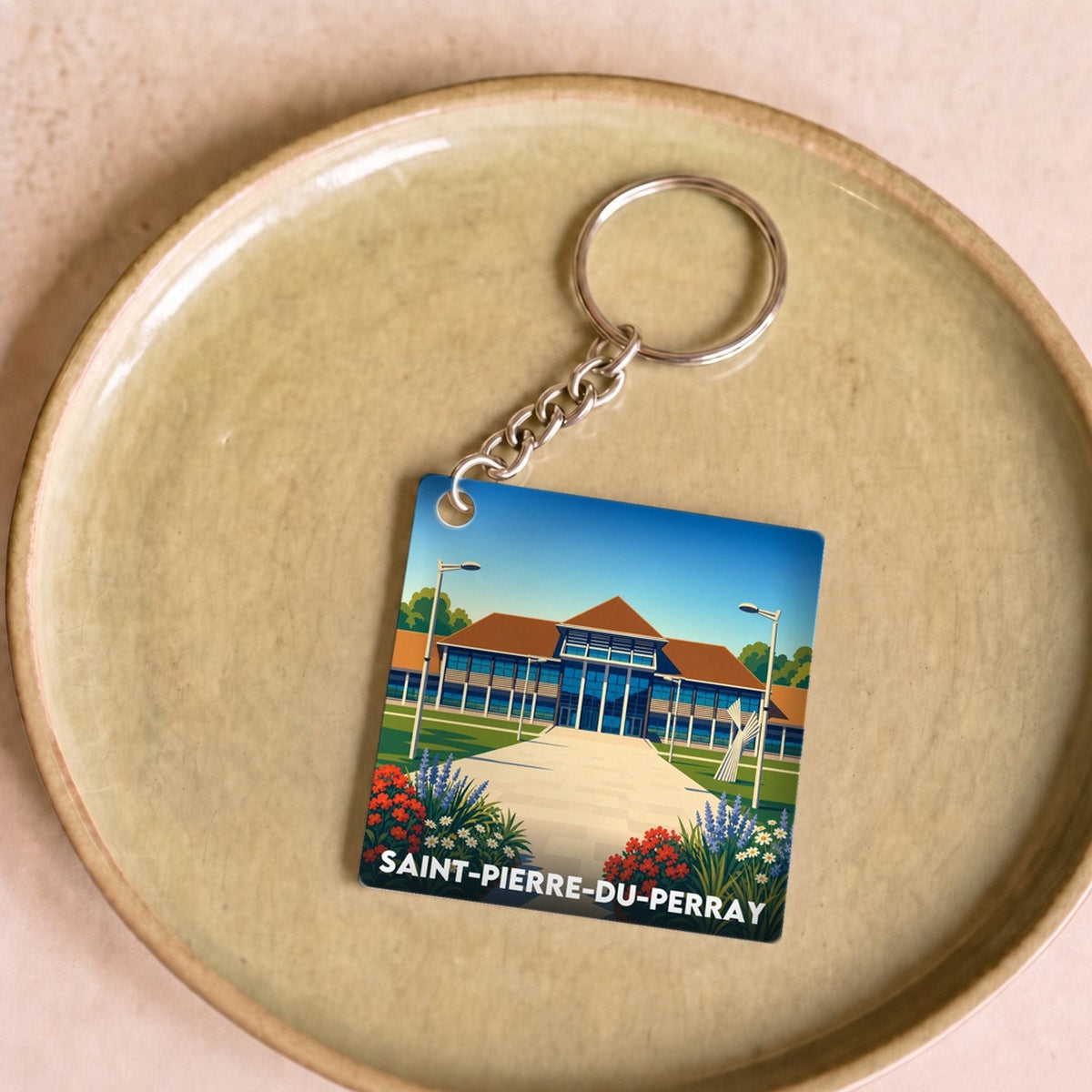 Porte-clés souvenir de la ville de Saint-Pierre-du-Perray avec une illustration stylisée.