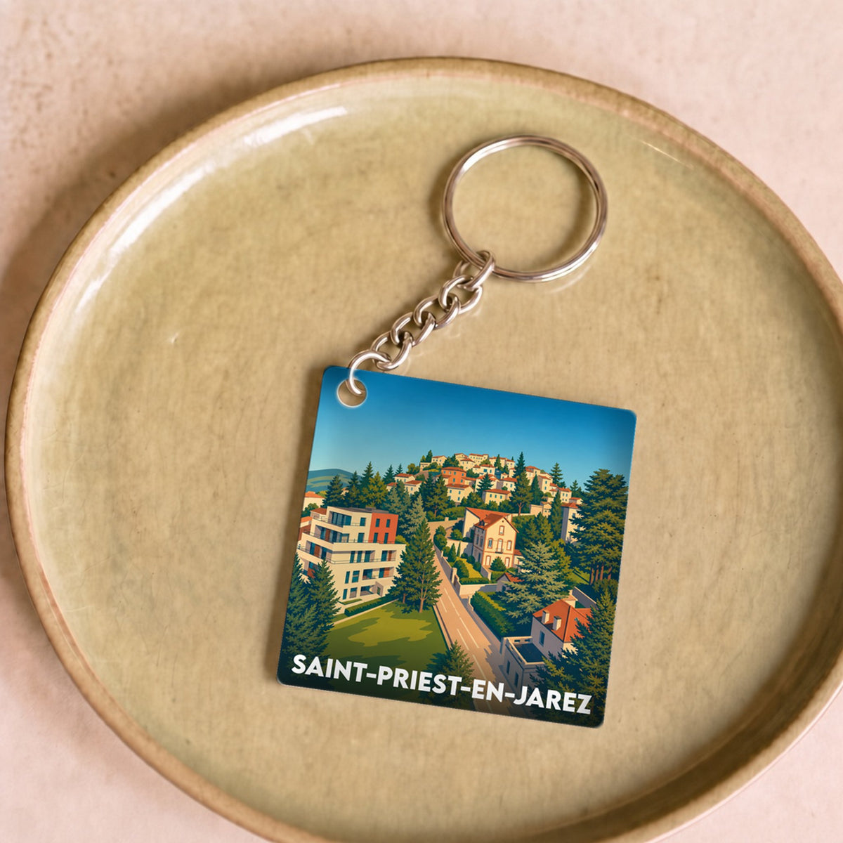 Porte-clés souvenir de la ville de Saint-Priest-en-Jarez avec une illustration stylisée.