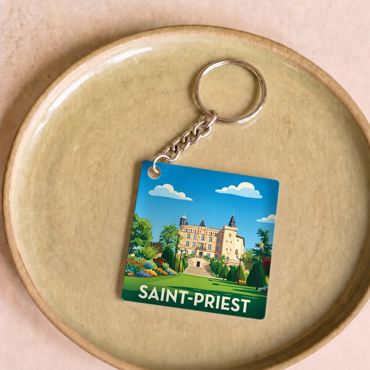 Porte-clés souvenir de la ville de Saint-Priest avec une illustration stylisée.