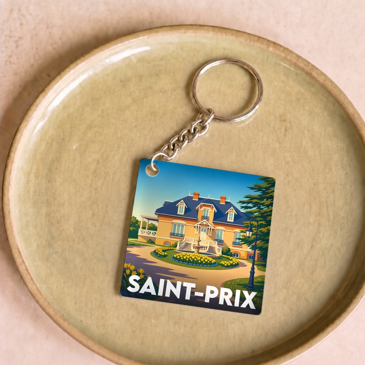 Porte-clés souvenir de la ville de Saint-Prix avec une illustration stylisée.