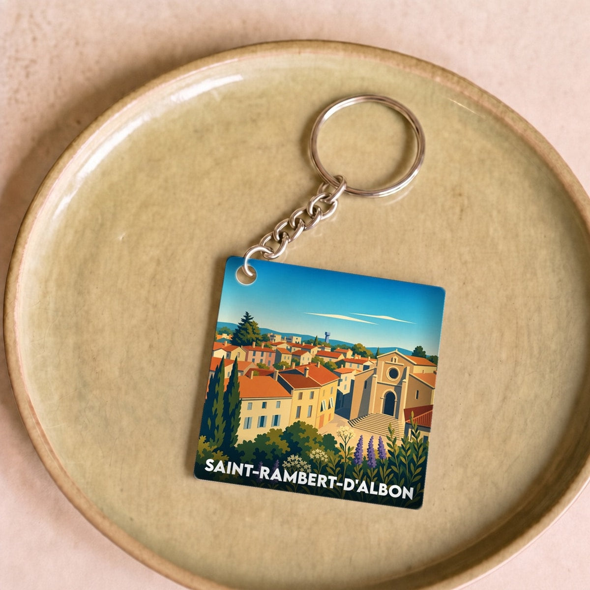 Porte-clés souvenir de la ville de Saint-Rambert-d'Albon avec une illustration stylisée.