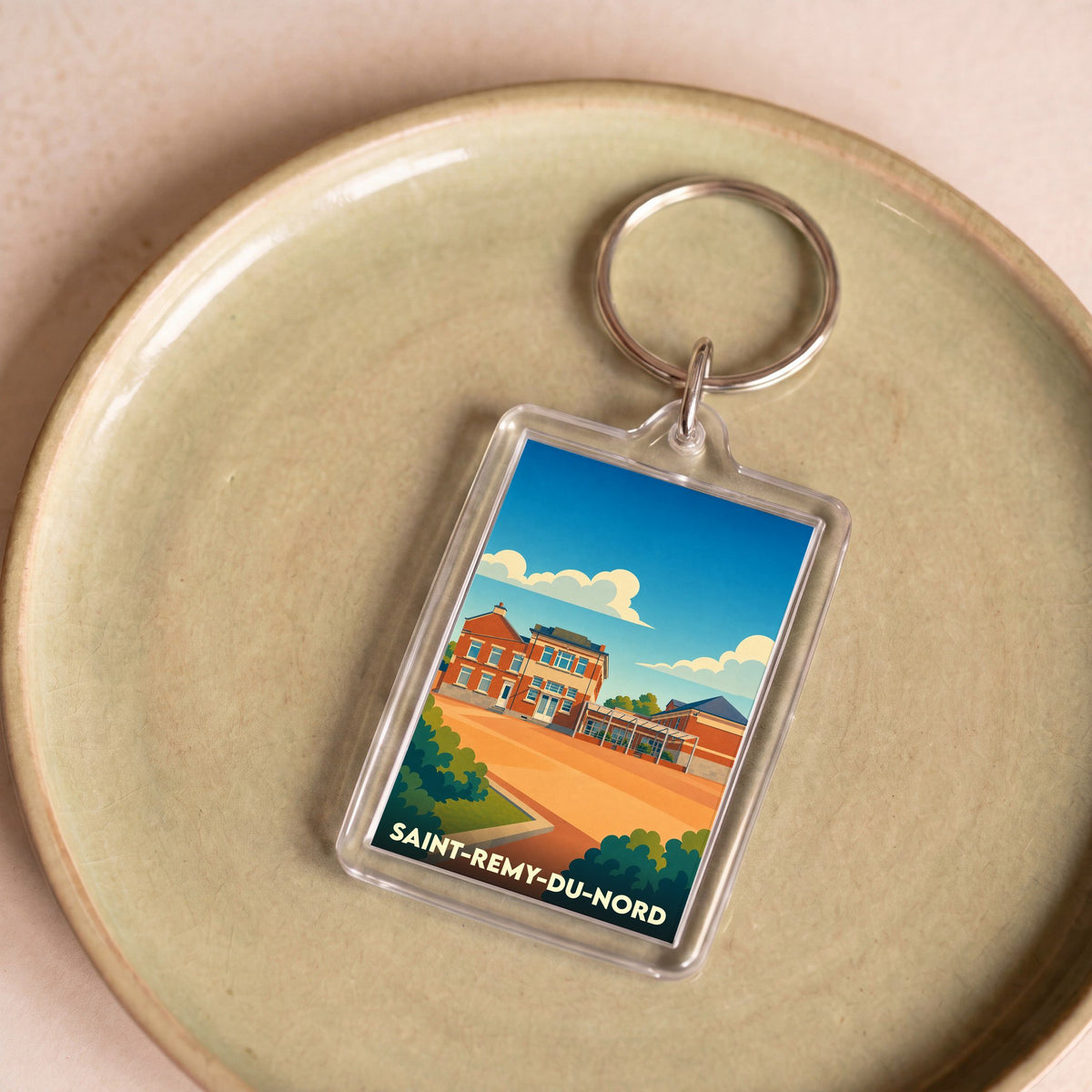 Porte-clés souvenir de la ville de Saint-Remy-du-Nord avec une illustration stylisée.