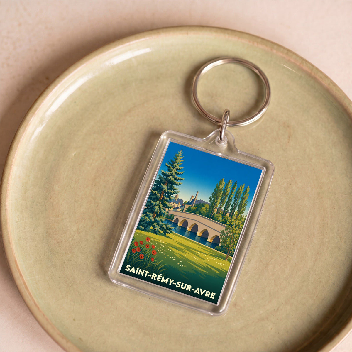 Porte-clés souvenir de la ville de Saint-Rémy-sur-Avre avec une illustration stylisée.