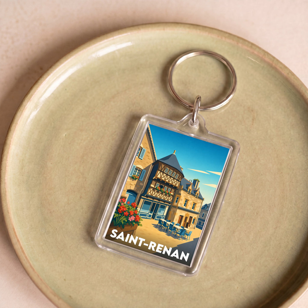 Porte-clés souvenir de la ville de Saint-Renan avec une illustration colorée et stylisée.