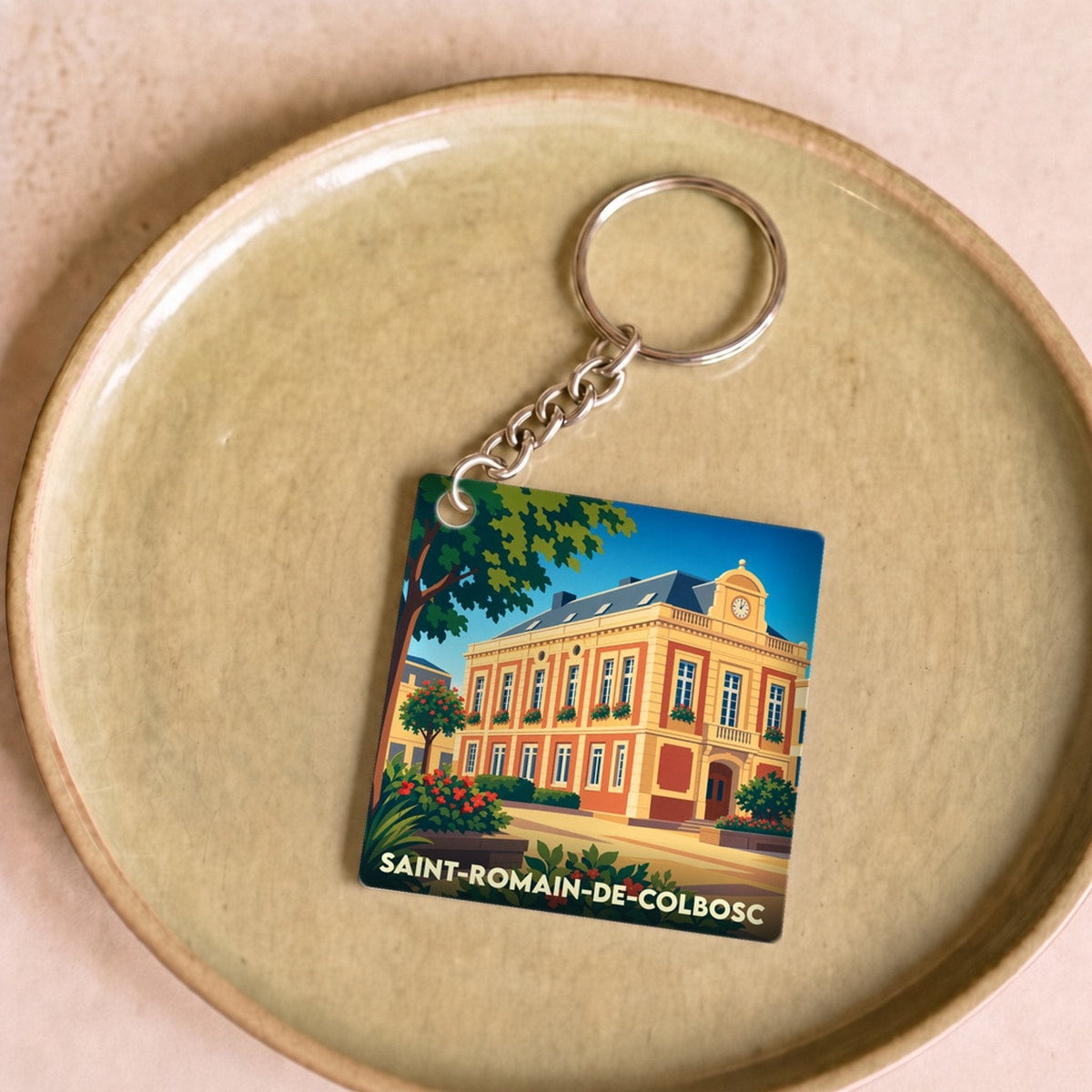 Porte-clés souvenir de la ville de Saint-Romain-de-Colbosc avec une illustration stylisée.